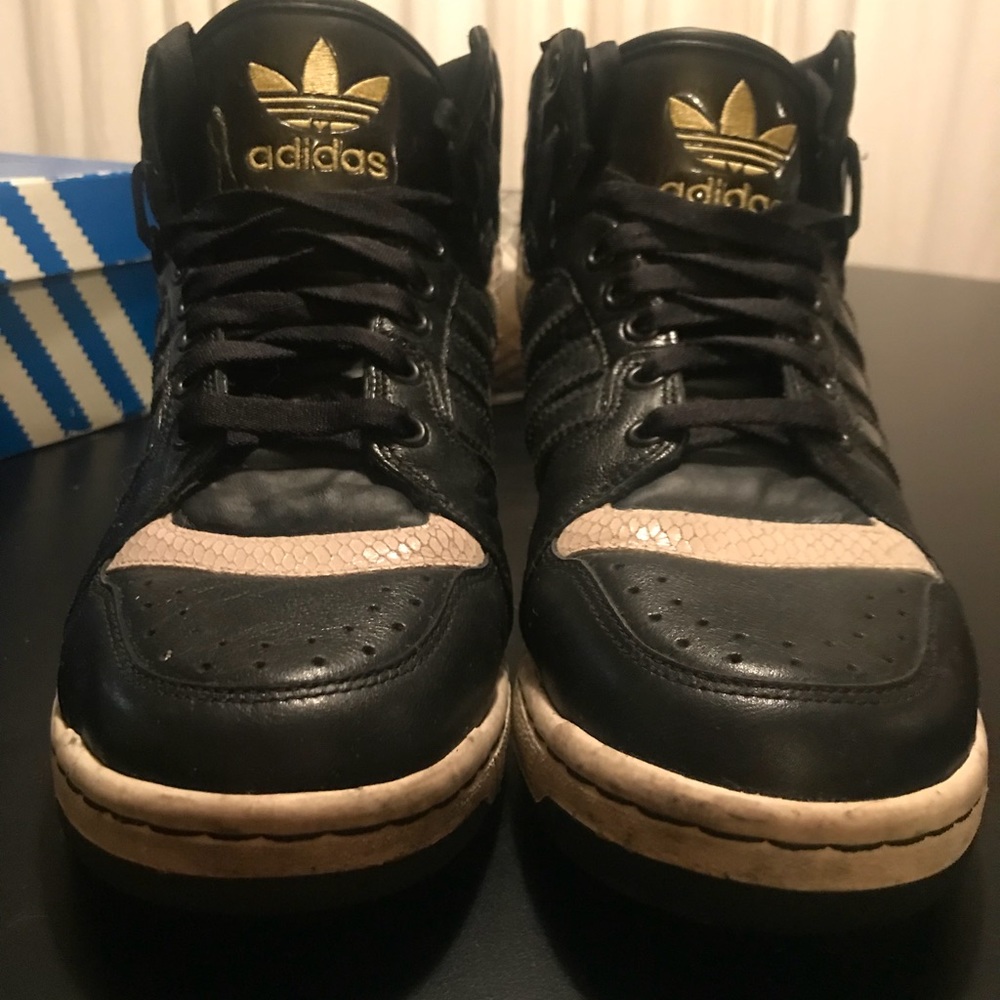 Adidas high tops black with white snake skin.